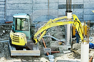 Winter work in construction site with excavator
