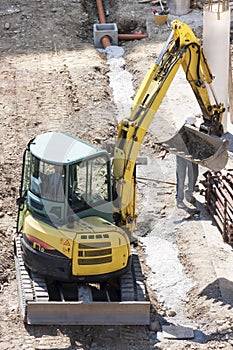 Winter work in construction site with excavator