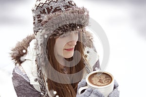 Winter young girl with cup of hot chocolate