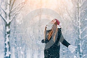 Winter young woman portrait. Beauty Joyful Model Girl laughing and having fun in winter park. Beautiful young woman