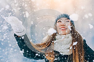 Winter young woman portrait. Beauty Joyful Model Girl laughing and having fun in winter park. Beautiful young woman