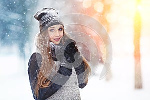 Winter young woman portrait. Beauty Joyful Model Girl laughing and having fun in winter park. Beautiful young woman outdoors. Enjo