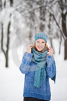 Winter young woman portrait. Beauty Joyful Model Girl laughing, having fun in winter park. Beautiful young woman laughing outdoors