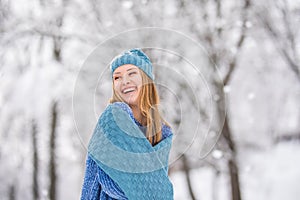 Winter young woman portrait. Beauty Joyful Model Girl laughing, having fun in winter park. Beautiful young woman laughing outdoors