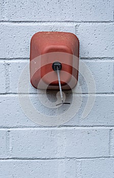 Winterization, foam and plastic faucet cover to prevent pipes freezing, on a painted brick wall