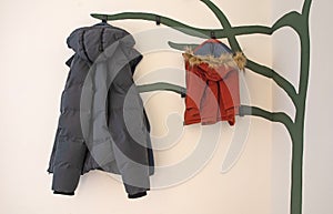 Winterjackets on a creative coathanger, large for dad, small for baby girl photo