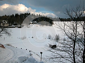 A winterlandscape with dark cloud, snow and small slope