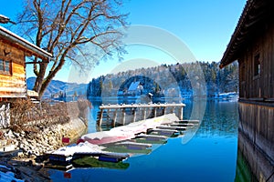 Winterlandscape at a lake with mirroring, reflections and blue sky