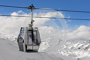 Tirol - ski gondola above the beautiful Alpine peaks covered in snow photo