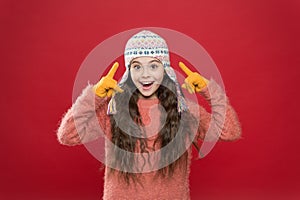 Wintertime concept. Little kid wear knitted hat. Little girl winter fashion accessory. Small child long hair wear hat