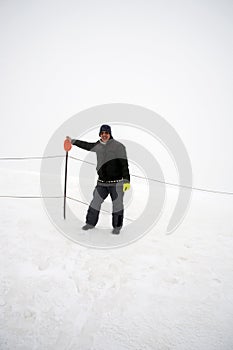 Wintertime: time to have fun in a ski resort. Snow, mountaintop, haziness, skiing.