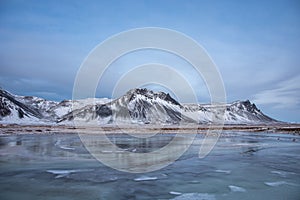 Wintry Icelandic Landscape With Frozen Lake And Snow Covered Mountains  