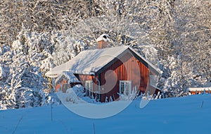 Wintry landscape with barn and house