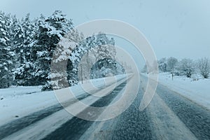 Wintry Path Through a Chilly Forest with Snow Covered Trees. Winter road through snowy forest