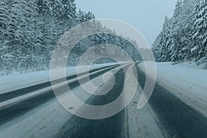 Wintry Path Through a Chilly Forest with Snow Covered Trees. Winter road through snowy forest