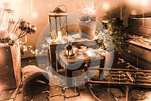 Wintry snowy outdoor Christmas decorations with sleigh, lanterns and fairy lights