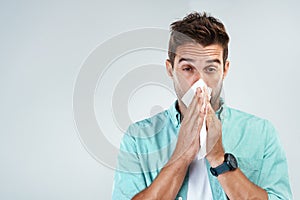 Wipe nose, tissue and portrait of man in studio with flu allergy, sickness and virus on white background. Handkerchief