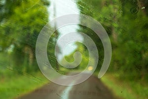 Wiped and blurred Rain drops on car windshield