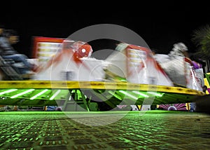 Wipeout Amusement ride night time colourful