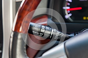 Wiper mode selection button with automatic adjustment through the rain sensor on the steering column of the car. The choice of
