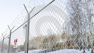 Wire barbed fence with security cctv cameras at the frontier zone on the border