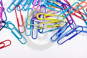 Wire colorful paperclips stack on white background
