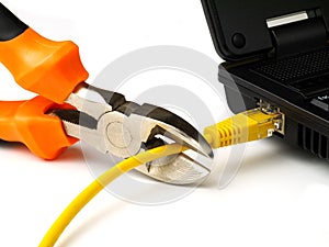 Wire cutter cutting network cable from laptop on white background