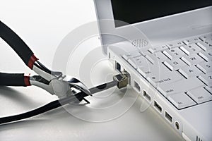 Wire Cutters Cutting Cable to Laptop