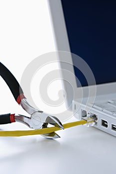 Wire Cutters Cutting Cable to Laptop