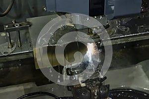 The wire-EDM machine cutting the die parts with the sparking light.