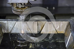 The wire EDM machine cutting  the mould parts . photo
