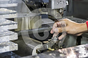 The  Wire EDM machine operator setting by insert the brass wire to the machine upper head. photo