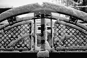 Wire fence and metallic net with snow. Metal net in winter covered with snow
