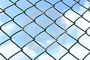 Wire fence on sky background