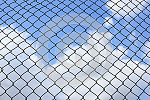 Wire fence on sky background