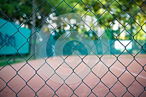 Wire fence with tennis field