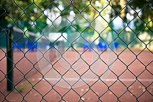 Wire fence with tennis field