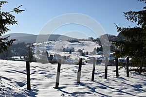 wire fence in the village during a snowy winter
