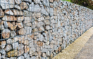 Wire Gabion Rock Fence. Metal Cage filled with rocks.