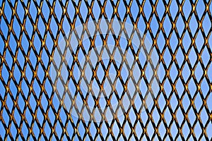 Wire grid fence background on blue sky background