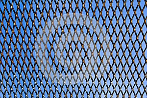 Wire grid fence background on blue sky background