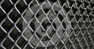 Wire mesh background and metallic seamless fence on black background
