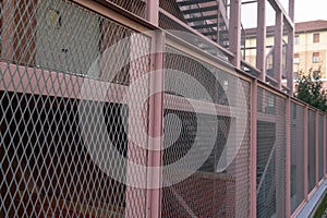 fence, metal grid, construction details of a steel frame building, school complex, campus