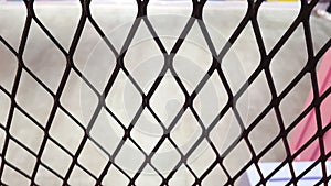 Wire mesh fence with blurred background of concrete floor