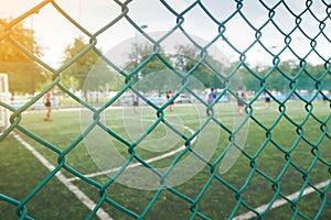 Wire mesh fence from football field with competitive.