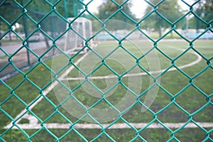 Wire mesh fence in soccer field.