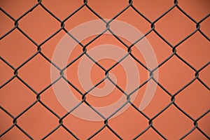 Wire mesh steel , fence with orange background