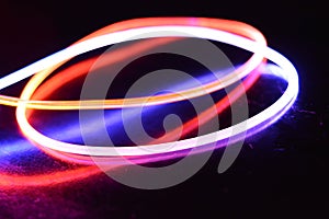 A wire with orange and blue light, a light guide wire with different light transmission, light spectrum, and light effects located