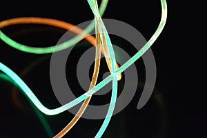 A wire with orange and gree light, a light guide wire with different light transmission, light spectrum, and light effects located