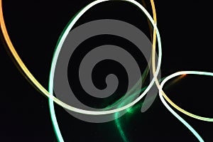 A wire with orange and gree light, a light guide wire with different light transmission, light spectrum, and light effects located